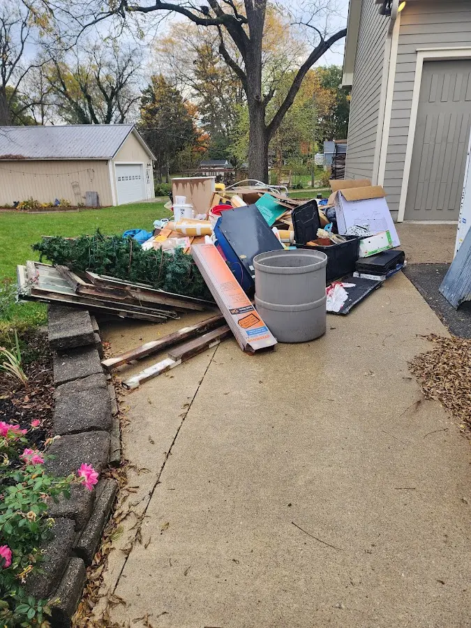 Dumpster being loaded with debris for Residential Dumpster Rental in Solon